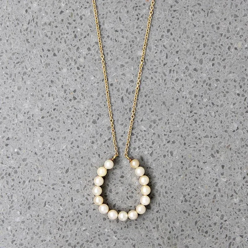Fortuitous Pearl-Set Gold Horseshoe Pendant