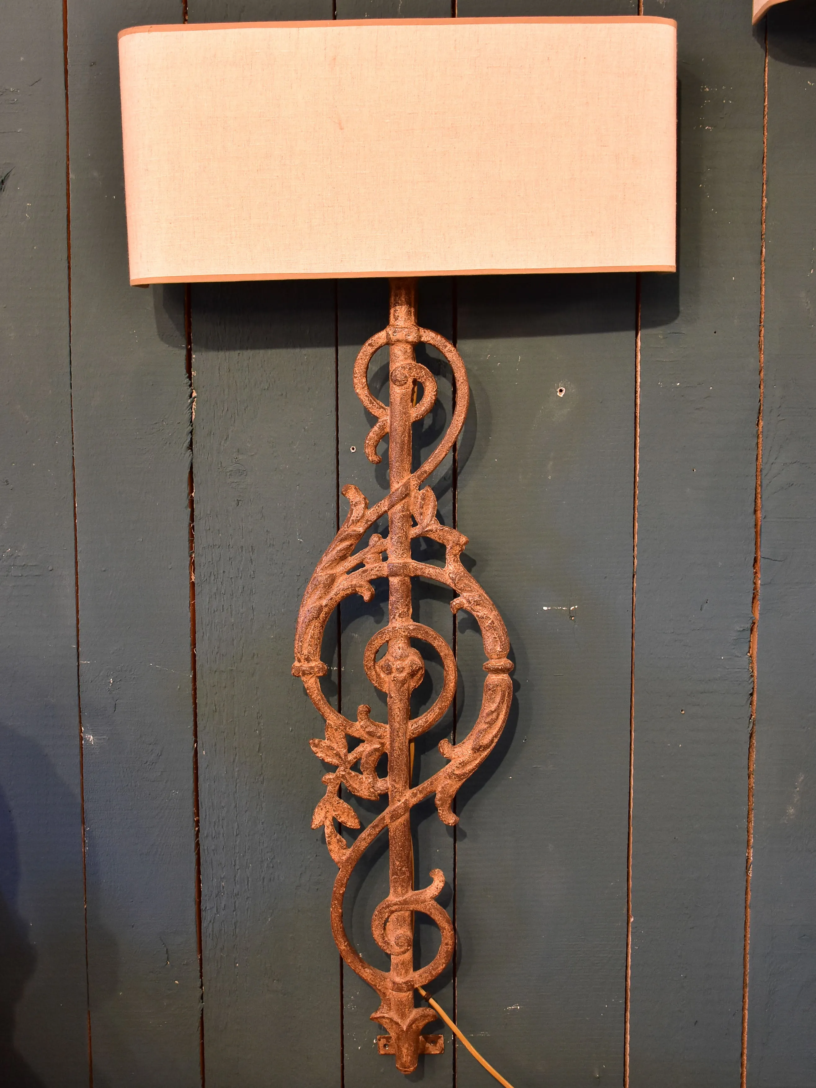 Pair of wall sconces made from salvaged iron from a balcony